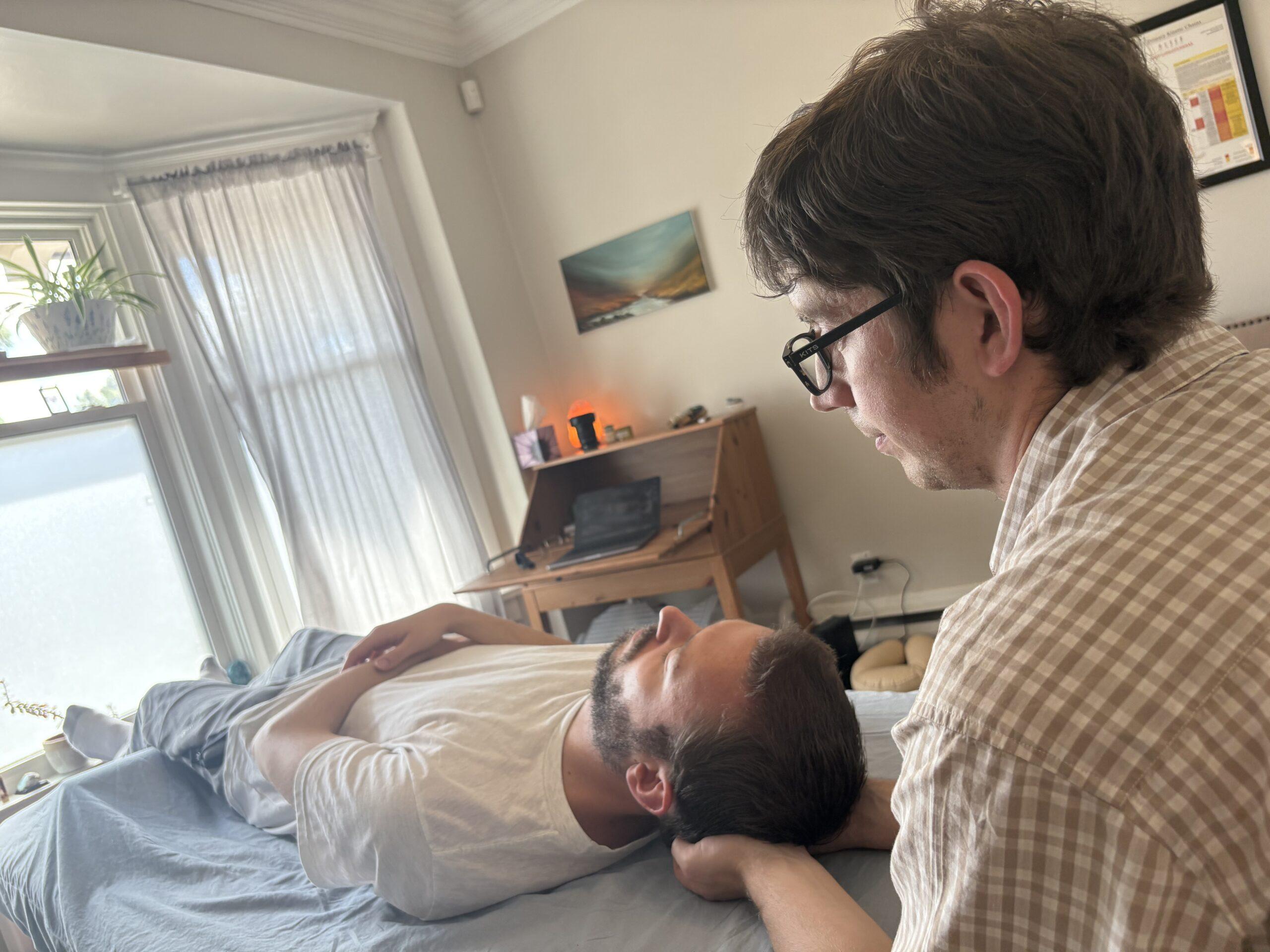 This is me treating a client with a craniosacral technique